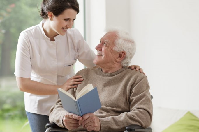 Photo,Of,Elderly,Man,Reading,Book,And,His,Private,Nurse