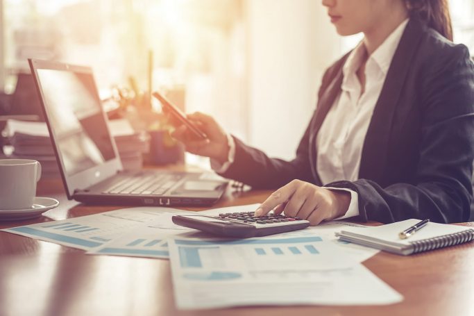 Business,Woman,Using,Calculator,And,Writing,Make,Note,With,Calculate.